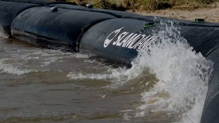 SLAMDAM water-filled flood barrier holding back floodwater